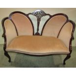 An Edwardian mahogany two seat parlour sofa, with upholstered seat and back pads within a shaped