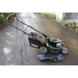 An Atco Quattro 195 self propelled petrol driven rotary lawn mower with grass collection bag