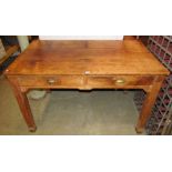 A vintage pine kitchen table of rectangular form fitted with two frieze drawers raised on four
