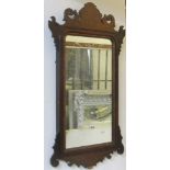 A 19th century mahogany wall mirror with shaped and fretted outline, 85 cm max