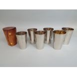 A cased set of six silver plated half pint capacity tumblers in a wrap around leather travel pouch