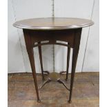 An Edwardian mahogany occasional table, the circular top raised on four slender turned supports,