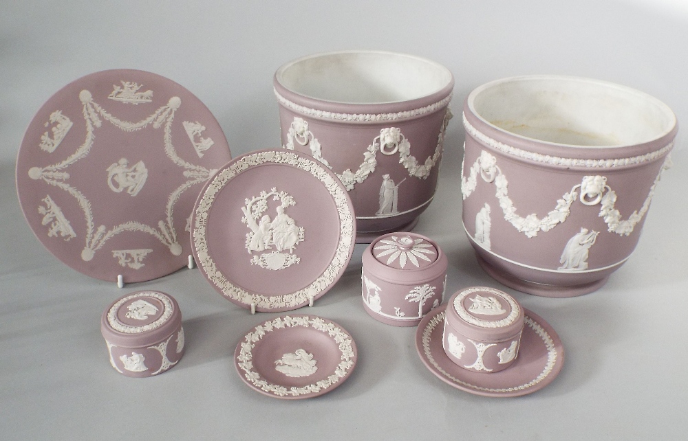 A collection of Wedgwood lilac ground Jasperwares comprising a pair of jardinieres with lion mask