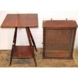 An arts and crafts walnut two tier occasional table, the square cut and moulded top raised on four