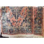 Pair of full pile Keshan type rugs with central blue medallion upon a pink or salmon ground, each