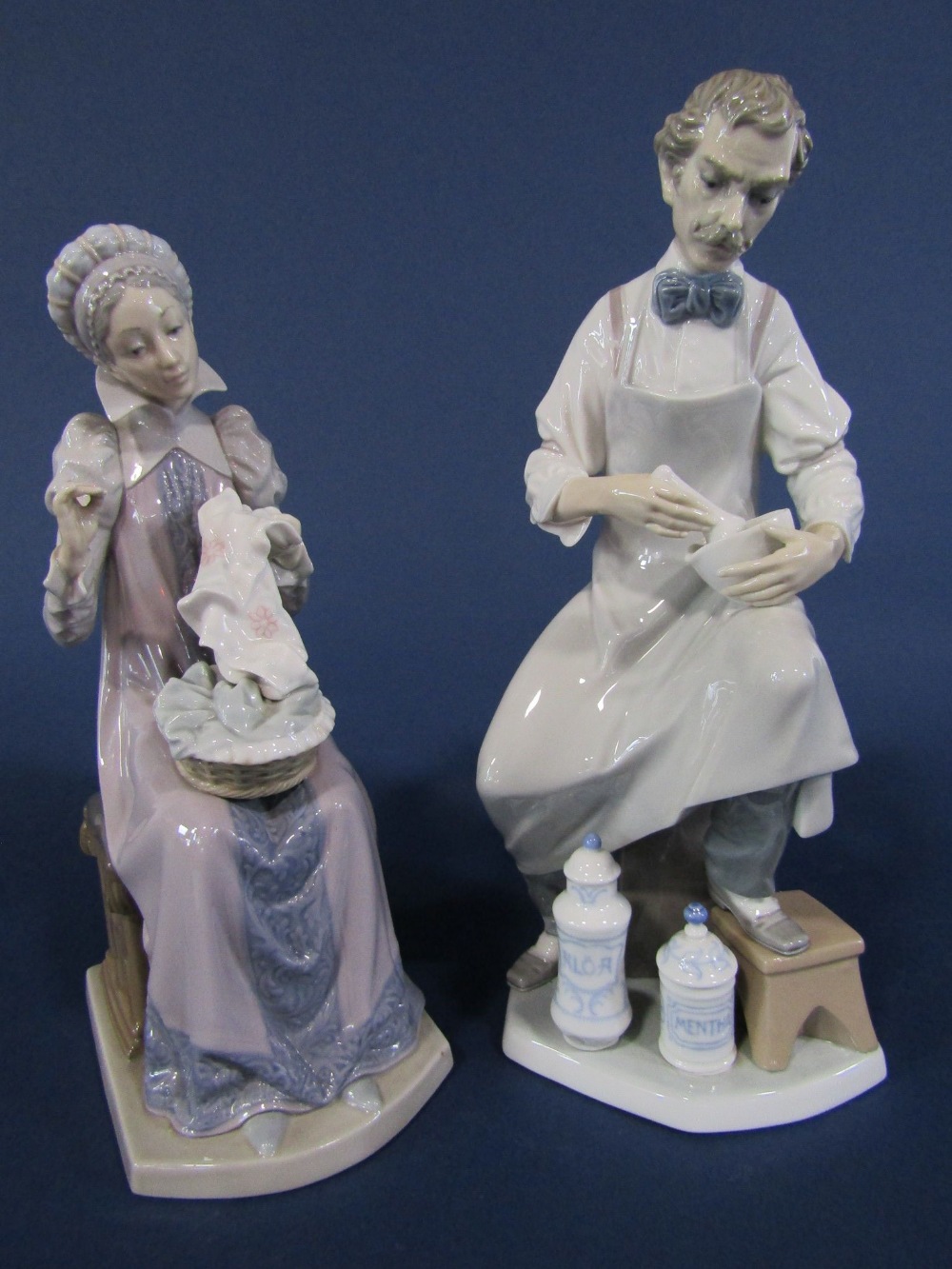 A Lladro Daisa figure of an alchemist, together with a Lladro Daisa figure of a woman with her