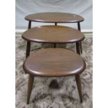 A nest of three graduated dark stained Ercol 'Pebble' occasional tables, raised on turned, tapered