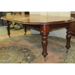 A Victorian mahogany extending D end dining table raised on four fluted supports, 240cm max, to seat