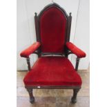 A substantial Victorian mahogany Gothic style armchair with arched back on gun barrel supports