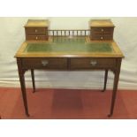 An Edwardian ladies writing desk fitted with two frieze drawers, the raised back supporting four
