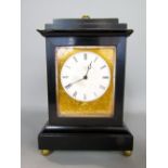 Small French mantel clock with ebonised case and gilt mask, circular enamel dial with Roman