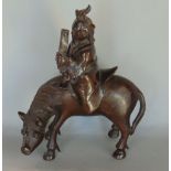 A Chinese bronze character group of an immortal/sage type character on horseback, 19 cm high