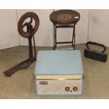 A small vintage folding industrial work stool with circular seat and X framed supports, together