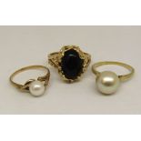 Three dress rings; vintage 14k example set with onyx, size T, further 14k example set with a large