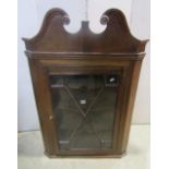 A Georgian oak Countrymade hanging corner cupboard with astragal glazed panel door, over a swan neck