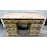 A Victorian stripped pine kneehole twin pedestal desk (one piece) fitted with an arrangement of nine