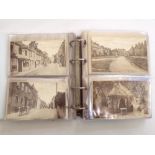 Two albums containing an extensive quantity of unusual and good quality black and white postcards of