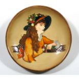 A RARE TRIAL MOORCROFT POTTERY PIN DISH TUBELINED AND DECORATED WITH A YOUNG WOMAN WEARING A