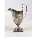 GEORGE III SILVER HELMET SHAPED CREAM JUG WITH REEDED RIM CHASED FLORAL DECORATION AND SCROLL HANDLE