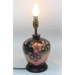 A MOORCROFT TABLE LAMP OF BULBOUS FORM, TUBELINED IN THE 'HONEYSUCKLE' PATTERN, ON A CIRCULAR