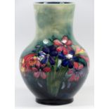 A MOORCROFT POTTERY VASE OF BALUSTER FORM, TUBELINED AND PAINTED WITH BUNCHED FLOWERS, SIGNED WITH