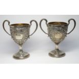A PAIR OF FINE GEORGE III IRISH SILVER TWIN HANDLED PRESENTATION GOBLETS EACH WITH TWO FOLIATE