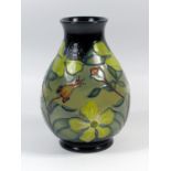 A MOORCROFT POTTERY VASE OF BALUSTER FORM DECORATED WITH TUBELINED FLOWERS AND FOLIAGE, IMPRESSED