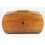 A REGENCY ROSEWOOD TEA CADDY OF ROUNDED RECTANGULAR FORM WITH INLAID BOXWOOD STRINGING, THE HINGED