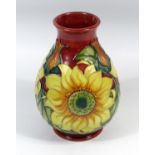 A MOORCROFT POTTERY VASE OF BALUSTER FORM, TUBELINED AND PAINTED WITH A FLORAL DESIGN, WITH