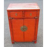 ORIENTAL RED LACQUER CABINET WITH TWO DRAWERS, TWO DOORS WITH METAL MOUNTS (H. 88.5 CM, W. 61 CM, D.