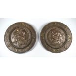 A PAIR OF ITALIAN BRONZE CIRCULAR WALL PLAQUES ONE WITH A NEAR NAKED MAN GRAPPLING A LION WITHIN A