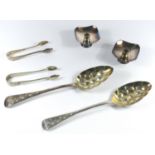 A PAIR OF VICTORIAN SILVER OLD ENGLISH PATTERN BERRY SPOONS, EACH WITH A GILT BOWL AND CHASED HANDLE
