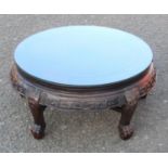 ORIENTAL CARVED HARDWOOD CIRCULAR COFFEE TABLE WITH DECORATED FRIEZE ON FIVE MASK CABRIOLE LEGS CLAW