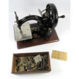 A WILLCOX & GIBBS MANUAL SEWING MACHINE WITH MANUFACTURER'S LABEL 'WILLCOX & GIBBS SEWING MACH.