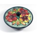 A MOORCROFT POTTERY BOWL WITH COVER, TUBELINED AND PAINTED WITH THE 'HIBISCUS' PATTERN, IMPRESSED '