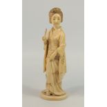 JAPANESE CARVED IVORY OKIMONO AS A FIGURE OF A COURTESAN, STANDING AND HOLDING A FAN, MEIJI