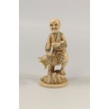 JAPANESE CARVED IVORY OKIMONO AS A FIGURE OF A MAN, STANDING AND HOLDING A BOX, SIGNED, MEIJI PERIOD