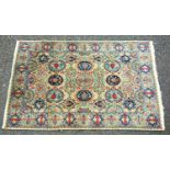 PERSIAN RUG, THE IVORY FIELD WITH ALL-OVER OVOLO AND FLORAL DECORATION SURROUNDED BY A FLORAL