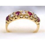 9 CT GOLD GARNET AND DIAMOND RING, SIZE Q 1/2, A SEVEN STONE SETTING (DIAMONDS APPROX. 3/16 TH