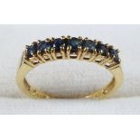 YELLOW METAL AND SAPPHIRE RING STAMPED 18 KT AND 750, SIZE N 1/2, SET SEVEN SAPPHIRES, GROSS