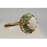 9 CT GOLD EMERALD AND OPAL CLUSTER RING, SIZE P, THE OVAL CABOCHON OPAL SURROUNDED BY TEN