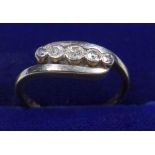 YELLOW METAL AND DIAMOND CROSSOVER RING, ENGRAVED AND STAMPED 18 CT., A FIVE STONE SETTING, GROSS