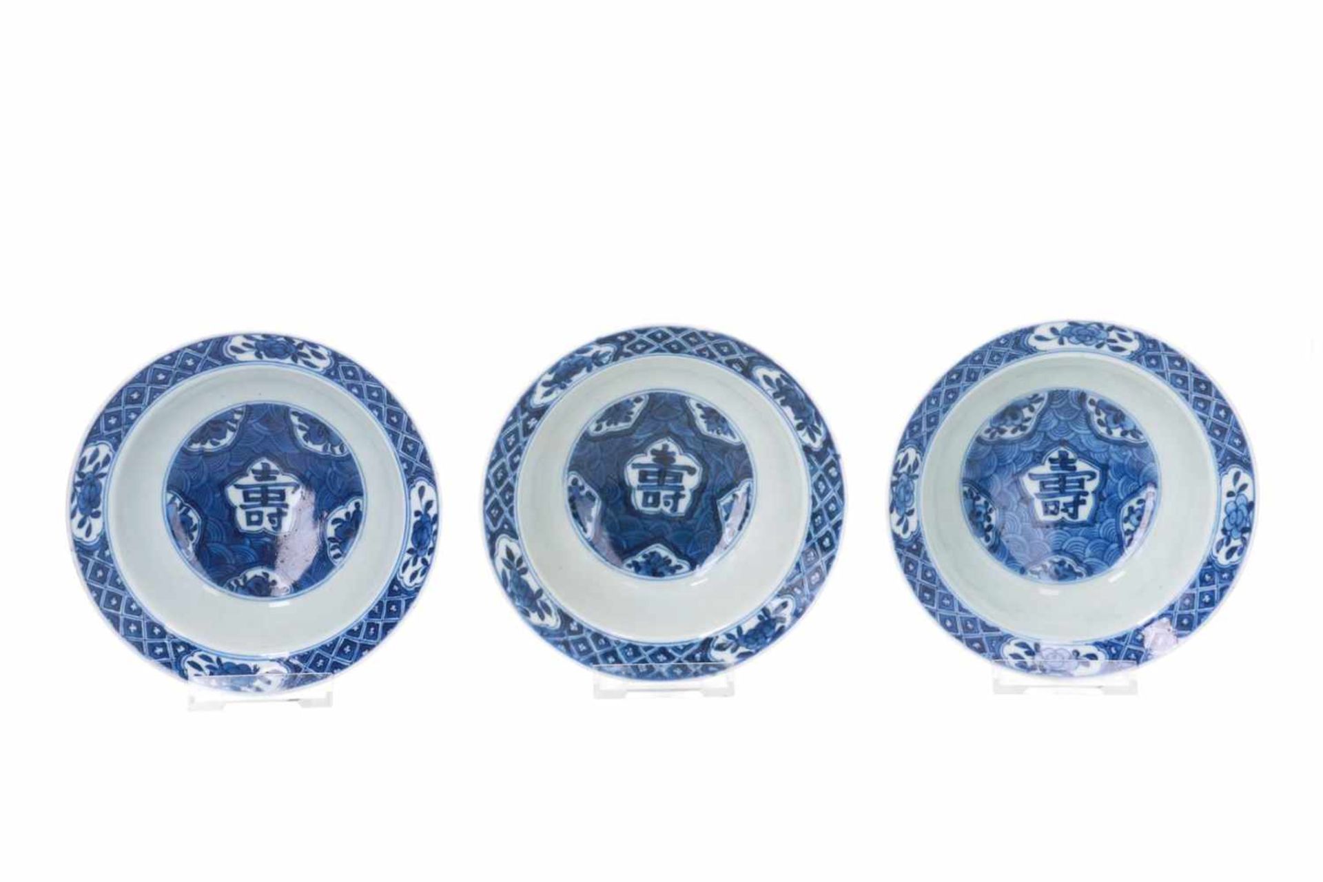 A lot of three blue and white porcelain bowls, decorated with flowers and Shou sign. Marked with 6-