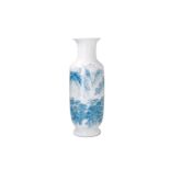 A blue and white porcelain vase, decorated with a mountainous landscape with houses. Marked with