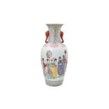 A polychrome porcelain vase with handles in the shape of elephant heads, decorated with figures, a