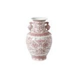 An underglaze red and white porcelain vase, decorated with flowers. The handles in the shape of