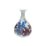A blue and underglaze red porcelain vase, decorated with two peacocks on flower branches. Marked