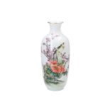 A polychrome porcelain vase, decorated with a bird and flowers. Marked. China, 20th century. H. 23