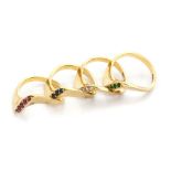 FOUR S-SHAPED STACKING RINGS comprising: pavé-set diamonds, rubies, emeralds and sapphires; each set