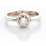 A RING tube-set with a round brilliant-cut stone, in 9ct white gold, ring size N